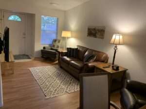 Cozy living room in mid term furnished rental Cottonwood with Smart TV and comfortable seating